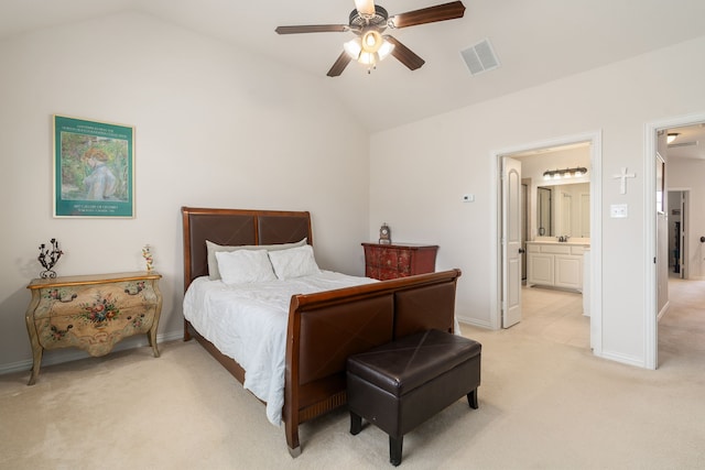 bedroom featuring ceiling fan, connected bathroom, vaulted ceiling, and light colored carpet