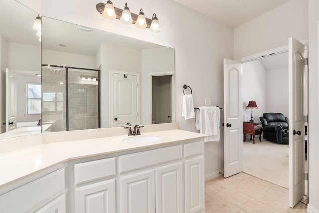 bathroom with tile patterned floors, a shower with shower door, and vanity