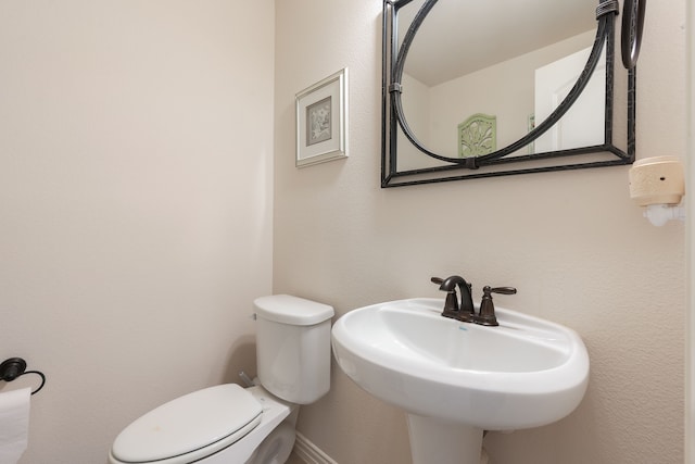 bathroom featuring sink and toilet