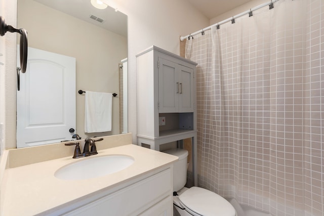 bathroom featuring vanity, toilet, and walk in shower