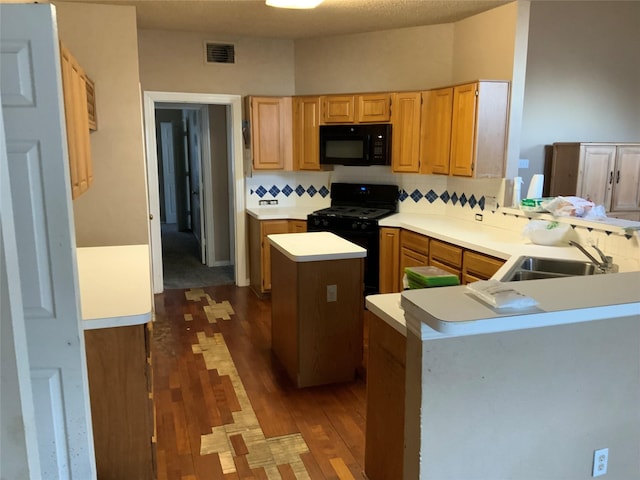 kitchen with sink, backsplash, a center island, black appliances, and kitchen peninsula