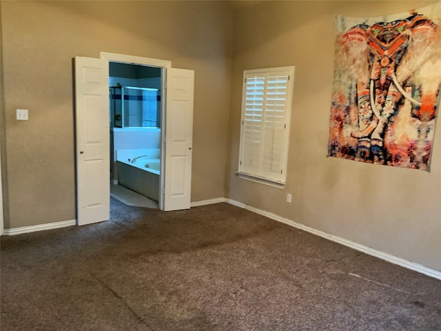 unfurnished bedroom featuring dark colored carpet