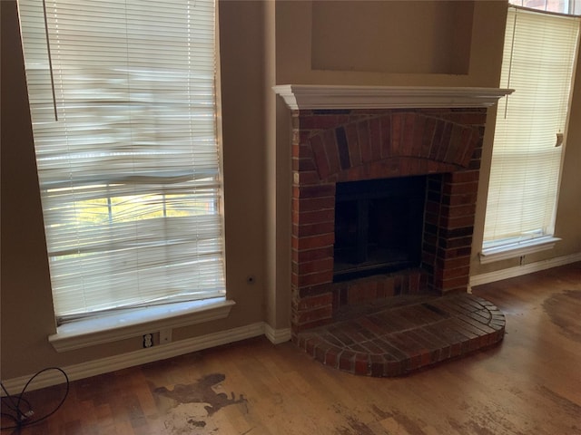 details with a brick fireplace and hardwood / wood-style floors