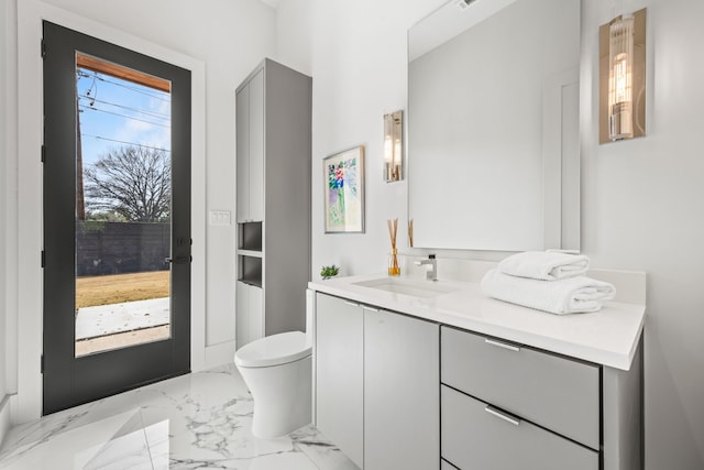 bathroom featuring vanity and toilet