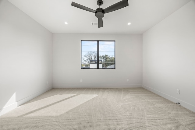 spare room with light carpet and ceiling fan