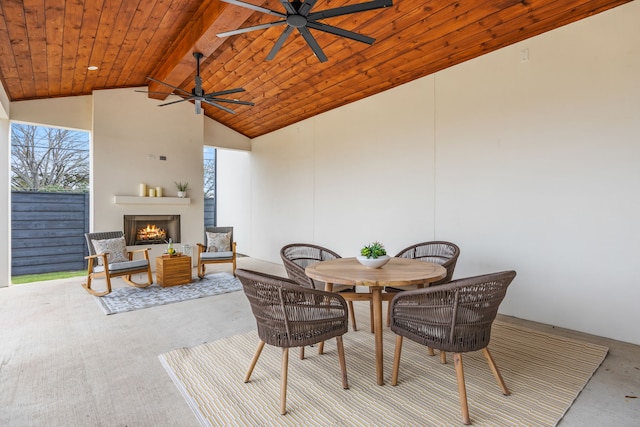 view of patio featuring ceiling fan and exterior fireplace