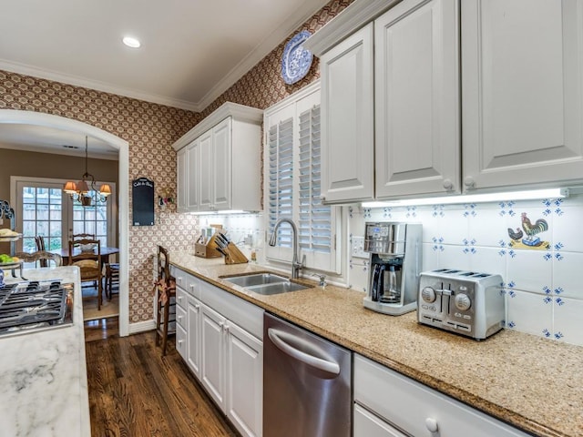 kitchen featuring ornamental molding, stainless steel appliances, sink, and white cabinets