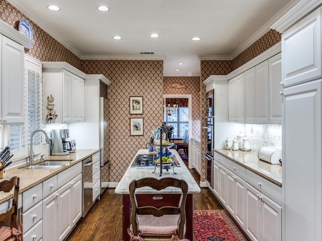 kitchen featuring sink, white cabinetry, ornamental molding, dark hardwood / wood-style floors, and light stone countertops