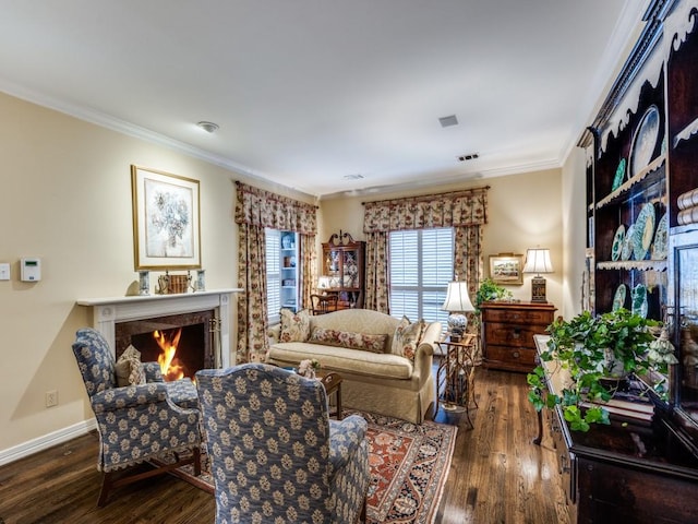 sitting room with dark wood-type flooring and crown molding