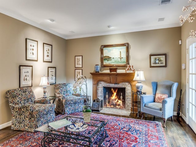 living area featuring crown molding, a fireplace, and dark wood-type flooring