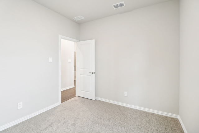 spare room with light colored carpet