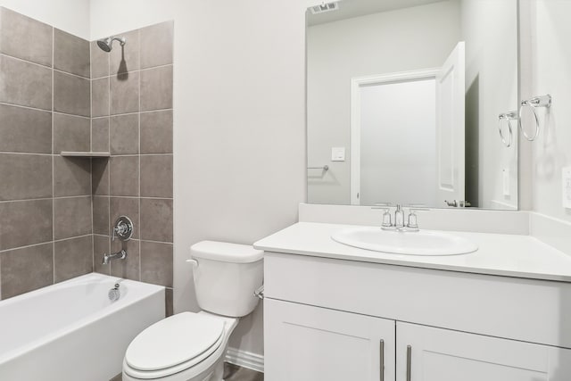 full bathroom with vanity, tiled shower / bath combo, and toilet