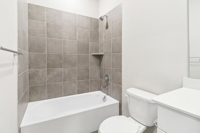 full bathroom with tiled shower / bath, vanity, and toilet