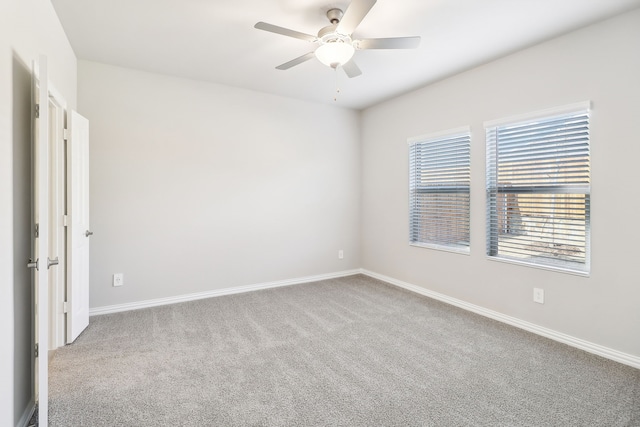 empty room featuring carpet floors and ceiling fan