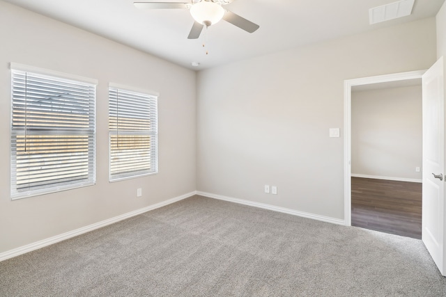 empty room with ceiling fan and carpet