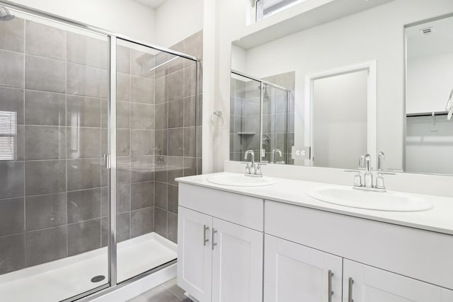 bathroom featuring walk in shower and vanity