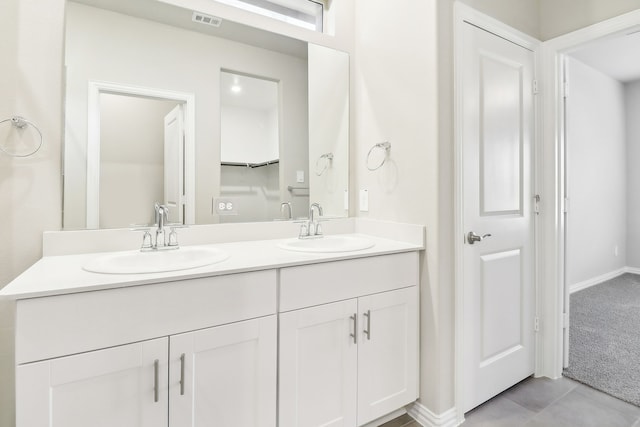 bathroom featuring tile patterned flooring and vanity