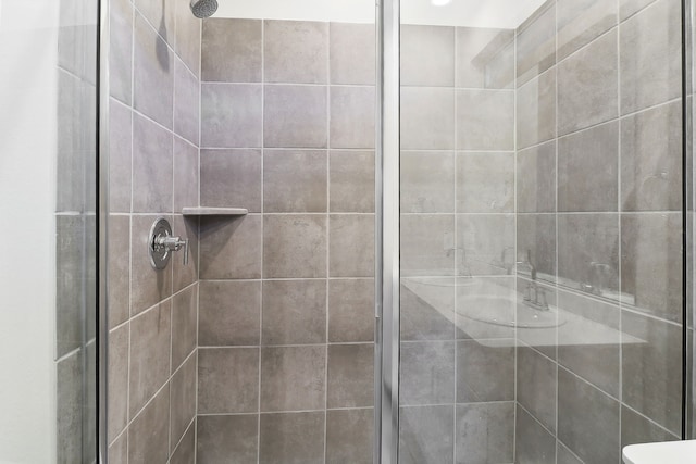 bathroom with tiled shower