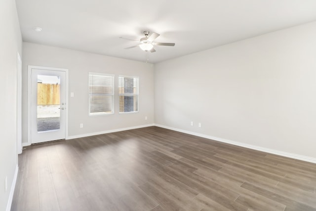 unfurnished room featuring ceiling fan and dark hardwood / wood-style flooring