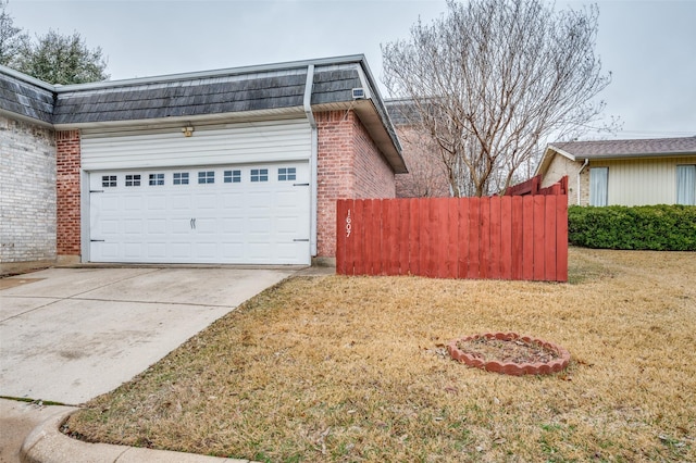 view of home's exterior with a garage and a yard