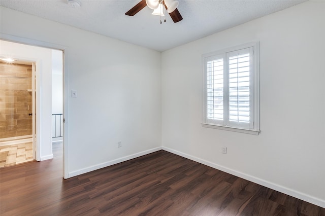 empty room with ceiling fan, a textured ceiling, and dark hardwood / wood-style flooring