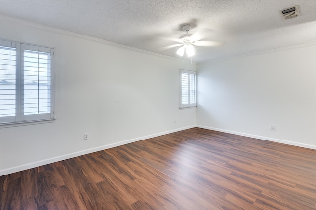 empty room with ceiling fan, ornamental molding, dark hardwood / wood-style floors, and a textured ceiling