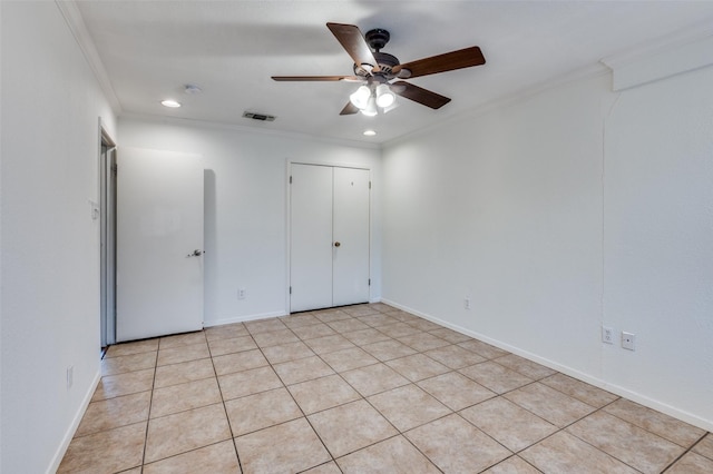 empty room featuring crown molding and ceiling fan