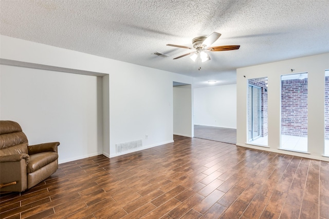 unfurnished room with ceiling fan, plenty of natural light, and dark hardwood / wood-style flooring