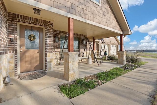 view of exterior entry with a porch