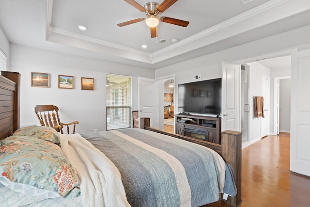 bedroom with ceiling fan, ornamental molding, and a tray ceiling