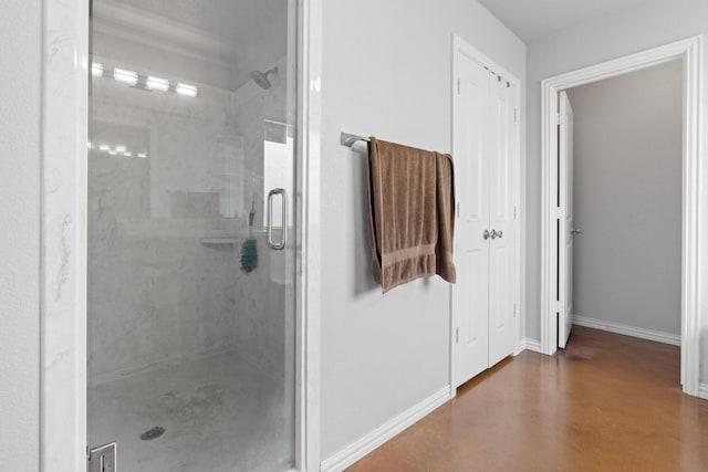 bathroom with an enclosed shower and concrete floors