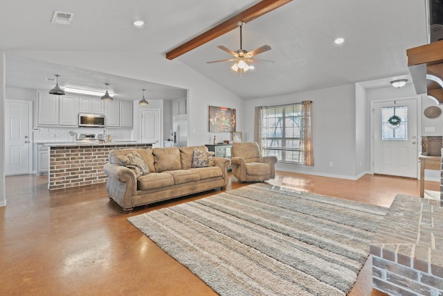 living room with vaulted ceiling with beams, a healthy amount of sunlight, and ceiling fan