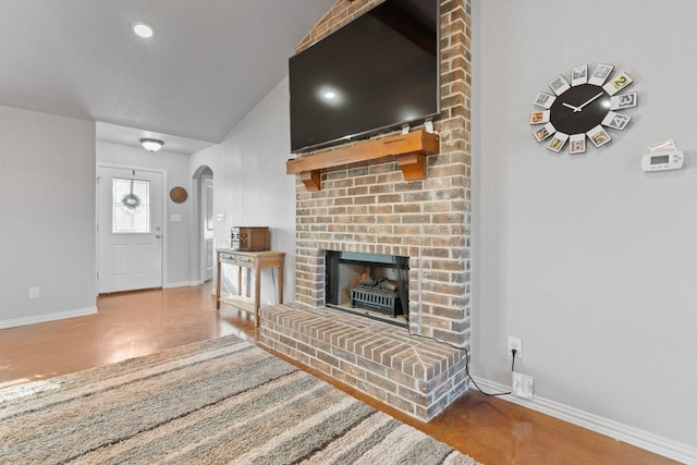 unfurnished living room with concrete floors and a fireplace