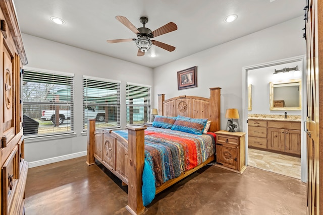 bedroom featuring ceiling fan, ensuite bath, and sink