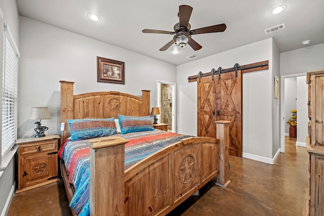 bedroom with ceiling fan and a barn door