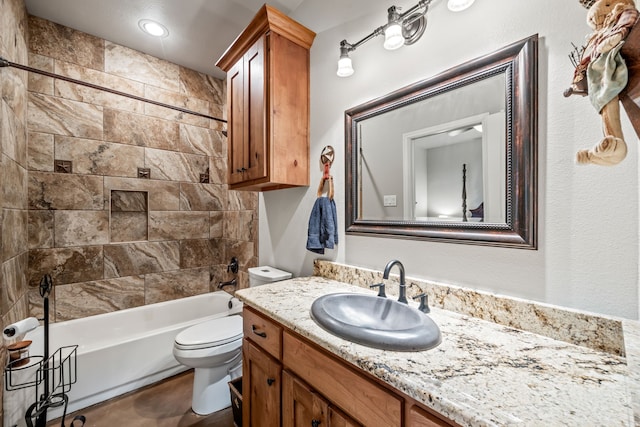 full bathroom with toilet, vanity, and tiled shower / bath