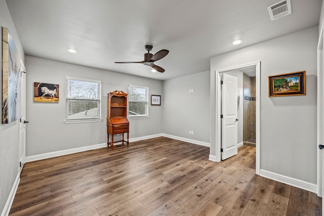 spare room with hardwood / wood-style floors and ceiling fan