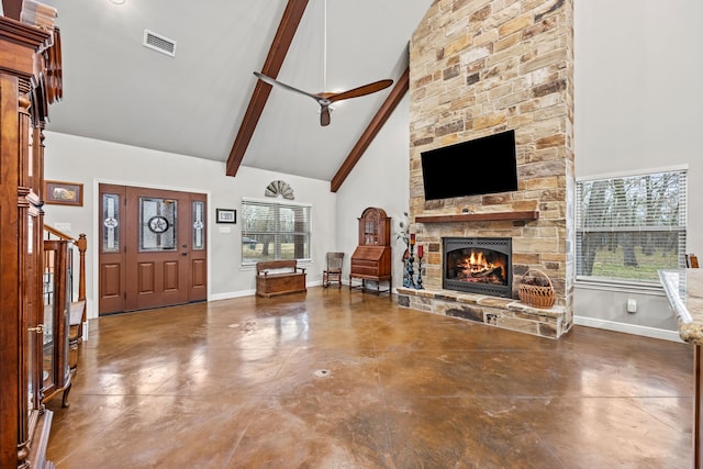 entrance foyer featuring a fireplace, concrete floors, ceiling fan, high vaulted ceiling, and beamed ceiling