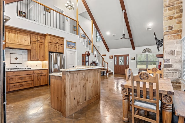 kitchen with high vaulted ceiling, stainless steel appliances, light stone counters, and tasteful backsplash