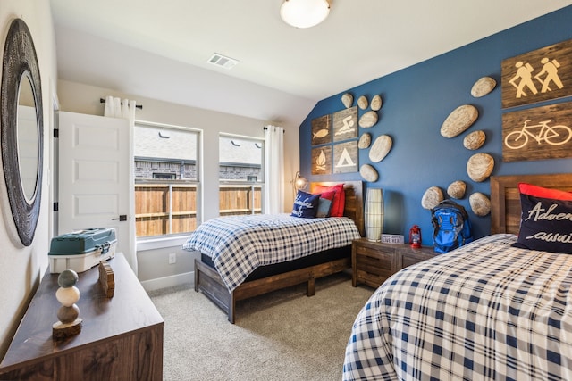 carpeted bedroom with vaulted ceiling