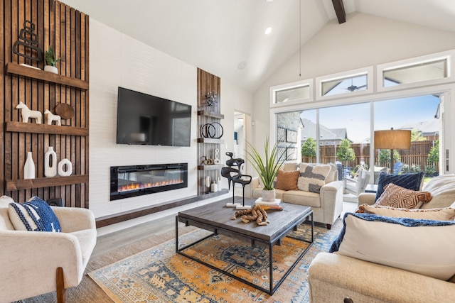 living room featuring hardwood / wood-style flooring, a fireplace, high vaulted ceiling, and beamed ceiling