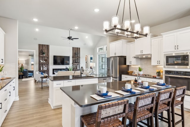 kitchen with pendant lighting, white cabinetry, stainless steel appliances, and sink