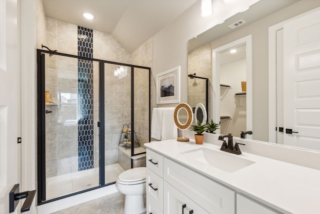 bathroom with lofted ceiling, toilet, a shower with shower door, vanity, and tile patterned flooring