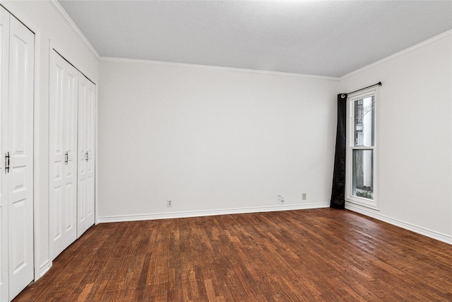 unfurnished bedroom with ornamental molding and dark hardwood / wood-style flooring