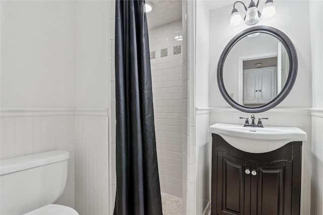 bathroom featuring vanity, curtained shower, and toilet