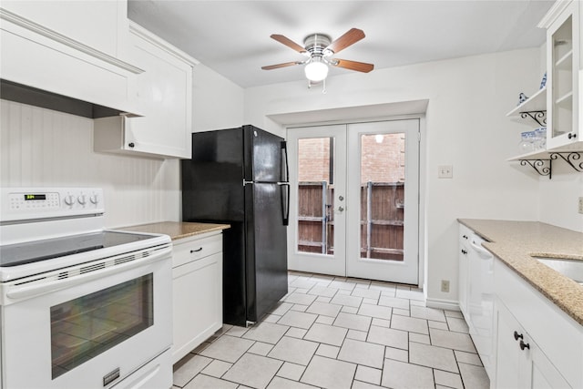 kitchen featuring white appliances, white cabinetry, light stone countertops, custom exhaust hood, and french doors