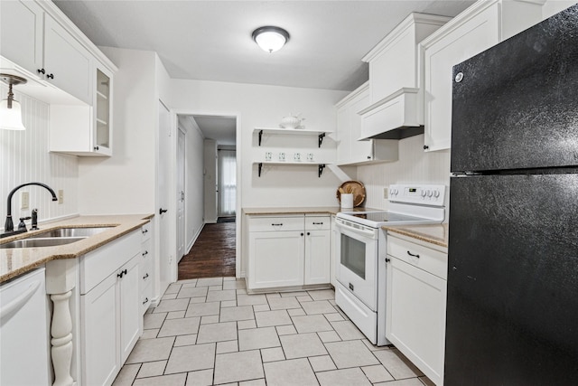 kitchen featuring sink, white appliances, white cabinetry, light stone counters, and custom range hood