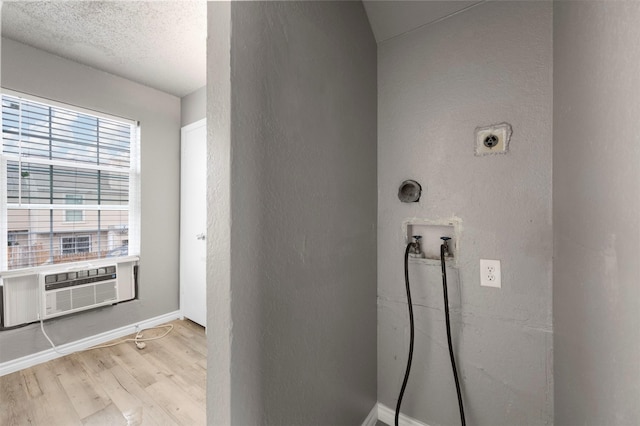 interior space with cooling unit, hardwood / wood-style floors, and a textured ceiling