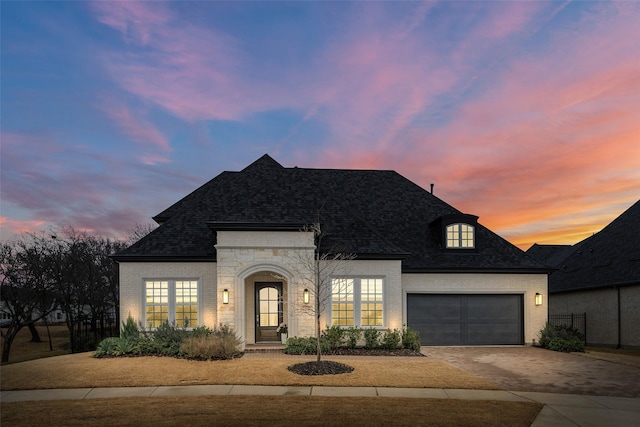 french country style house with a garage