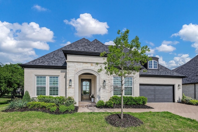 350 Pearland Dr, Prosper, TX 75078 - french country style house with a front lawn, driveway, stone siding, and a garage